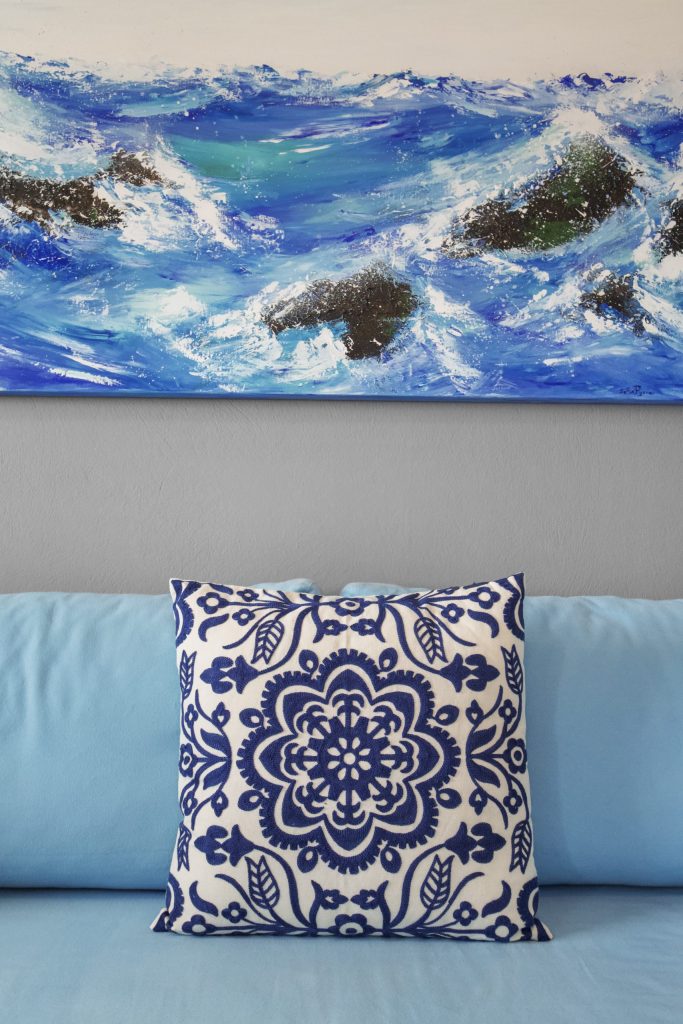 Sofa detail beneath a sea painting