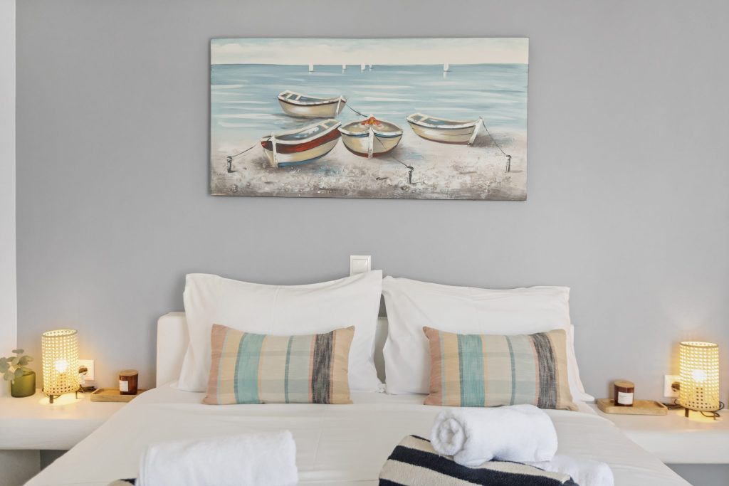 Bedroom with framed coastal art